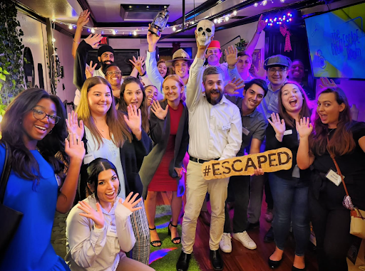 Group of escape room players holding a #escaped